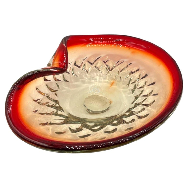 Mid-Century Italian Murano Art Glass Folded Edge Bowl w/ Ruby Rim: An exceptional Mid-Century era Murano art glass bowl showcasing a rich ruby-red rim that gently transitions into warm amber and clear tones. Its sculptural form flows into a graceful with a distinct f