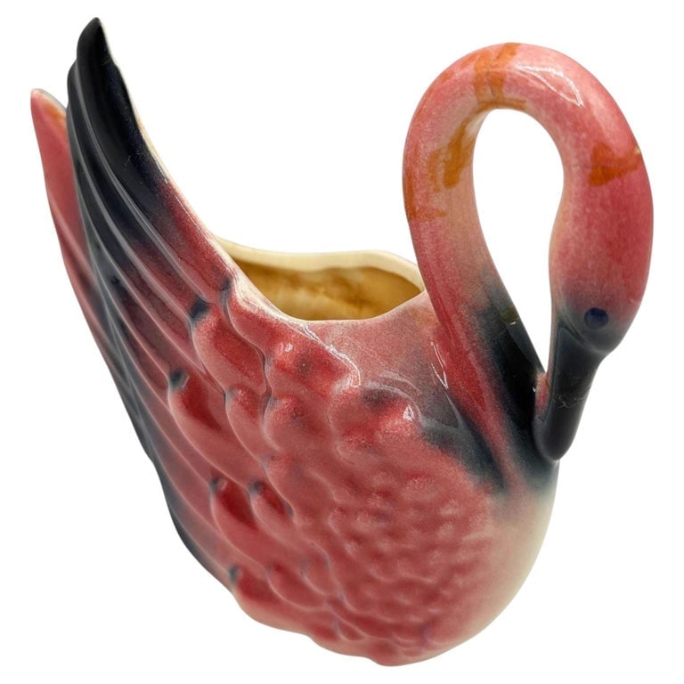 Mid-Century California Pottery Ceramic Tropical Pink Flamingo Planter: Mid-century era pink and green ceramic flamingo tabletop Planter. The planter features a beautifully detailed pink flamingo bowing their head at the waterline . It comes in a gloss finish that highlig