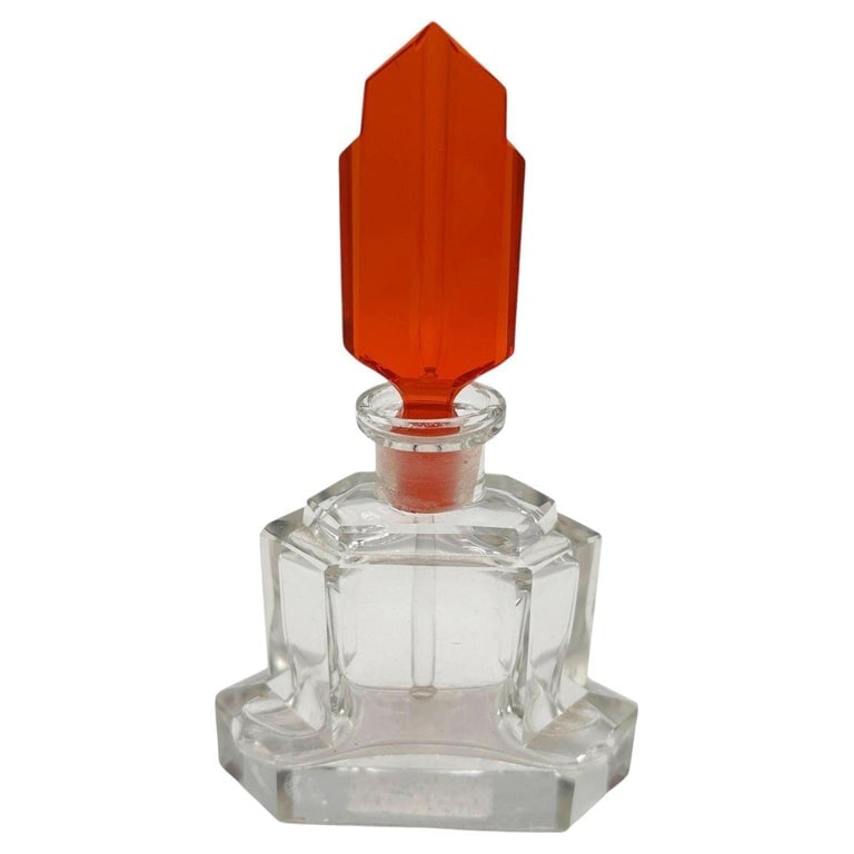 Art Deco Karl Palda Style Geometric Crystal Perfume Bottle w/ Coral Red Stopper: Art Deco geometric crystal perfume bottle in the style of Karl Palda with coral red Opaline stopper. The bottle features a heavy, clear crystal base with sharp, multi-tiered geometric faceting that ca