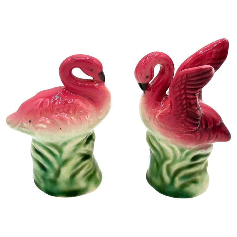 Mid-Century Pink Flamingo Ceramic Salt and Pepper Shaker Set, Lefton's Japan: Mid-Century pink and green ceramic flamingo tabletop salt and pepper shaker set. The set features two beautifully detailed pink flamingos in lush green leaves and grass with a pink color. Each comes