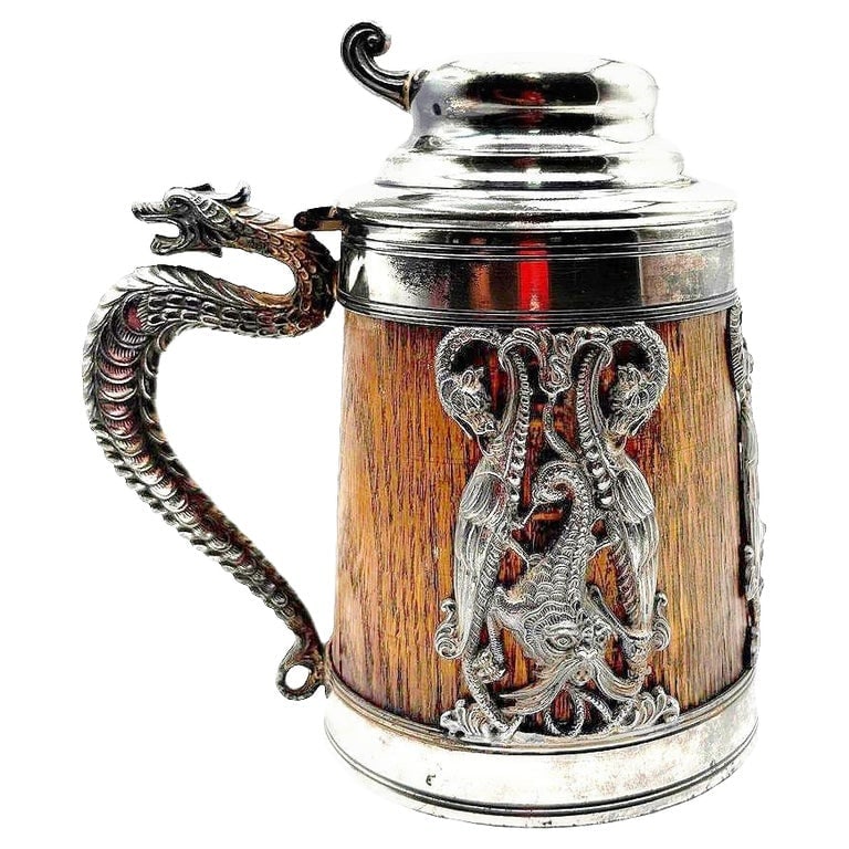 Silverplate Oak Tankard Beer Stein w/ Dragon motif, by St. Louis Silver Co.: A striking antique beer stein by the St. Louis Silver Company, combining an Oak tankard shape with silver-plated mounts. The piece features a dramatic dragon-form handle with finely detailed scales