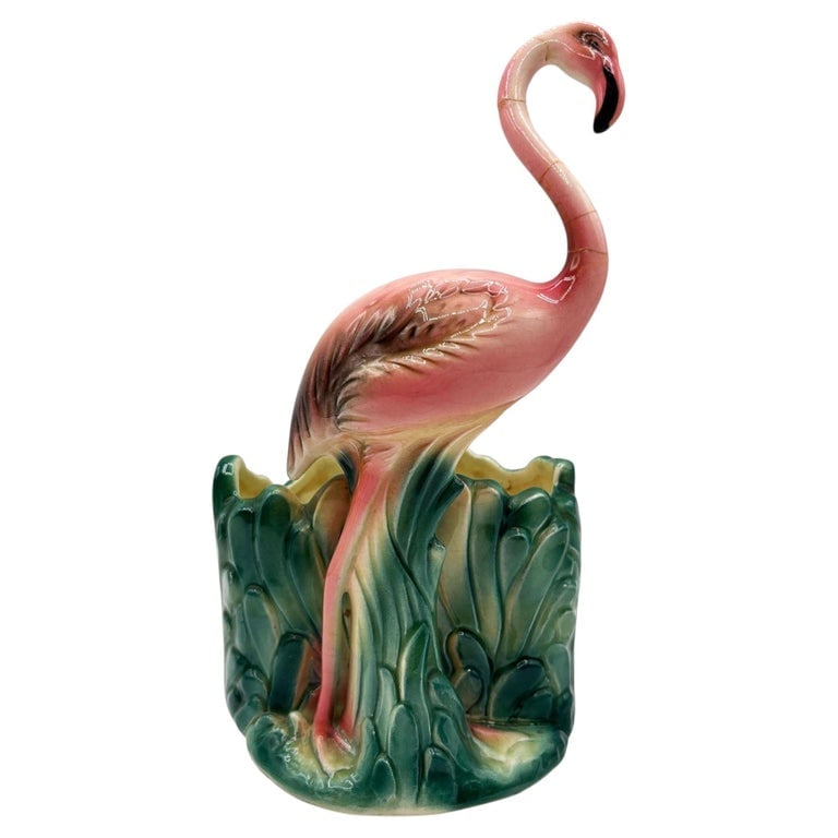 Mid-Century Tropical Pink Flamingo Ceramic Tabletop Planter by Napco: Mid-century pink and green ceramic flamingo tabletop Planter by Napco. The planter features a beautifully detailed pink flamingo walking on a lush green grassy field. It comes in a gloss finish that