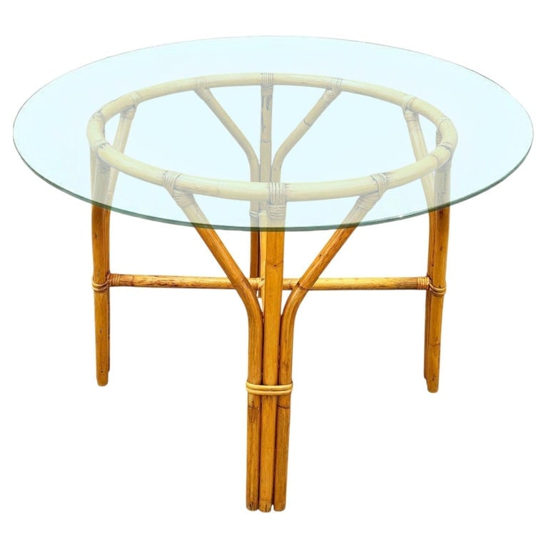 Restored Mid-century Round Glass Top 3-Strand Rattan Dining Table: This beautifully restored round Frankl-inspired round rattan dining table features a sculptural 3-strand rattan base with a round glass top. The table blends style and vintage charm with modern comfor