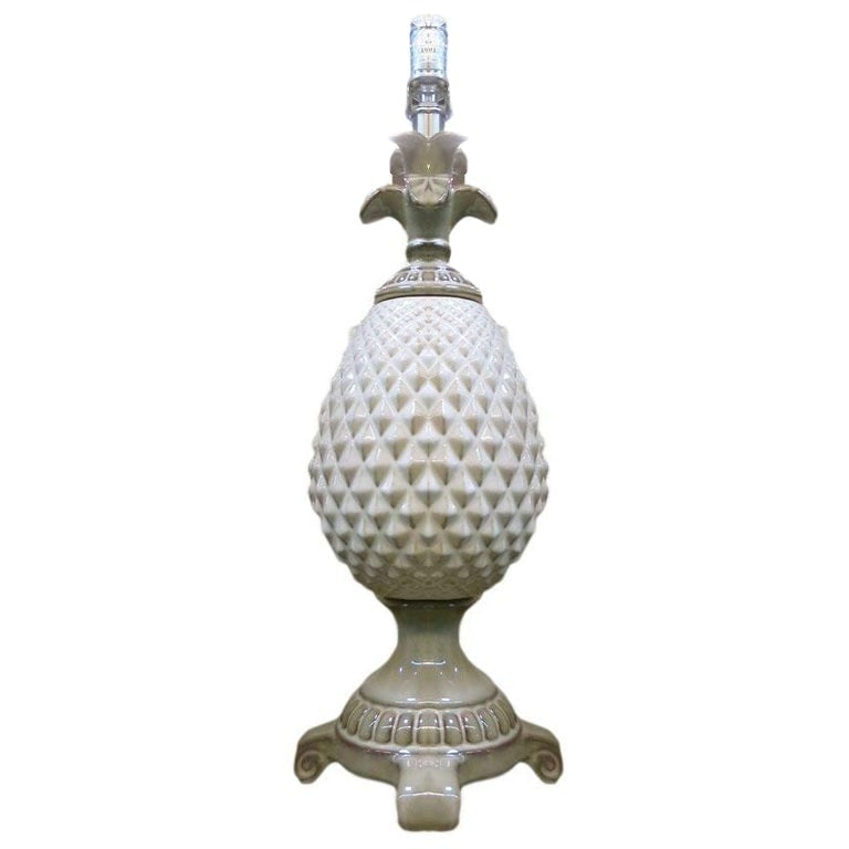 Mid-Century White Ceramic Pineapple Pedestal Lamp - Single: Late Mid-Century Pineapple lamp crafted in ceramic with a taupe and white finish. The body of the lamp is made of a pineapple shape with a raised pyramid pattern on top of a Greek-style footed column 