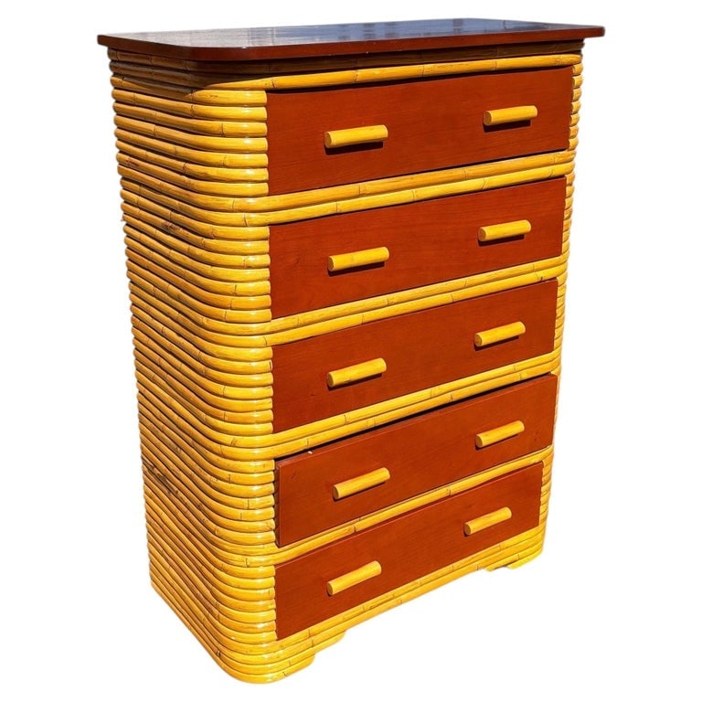 Restored Paul Frankl Style Stacked Rattan and Mahogany Art Deco Highboy Dresser: This beautifully restored coastal Art Deco era rattan chest of drawers with a mahogany top and five pull-out mahogany fronted drawers. The petite dresser is a perfect blend of functionality and Pacifi