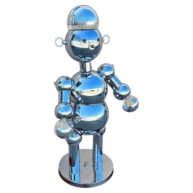 1975 Post-Modern Chrome Bubble Ball Robot Table Lamp by Torino Lamps: The 1970s chrome ball joint robot lamp by Torino Lamps is a striking, retro piece of functional art, combining futuristic design with a playful character. The lamp was made by the Torino Lamp Company 