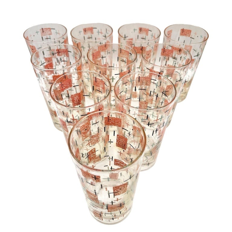 Mid-Century Googie Print Atomic and Starbursts Midmod Cocktail Glass, Set of 10: This set of ten premium cocktail glasses epitomizes Mid-Century Googie style. Featuring a vibrant atomic print of coral rectangles, black crosses, and teal starbursts, these glasses offer an