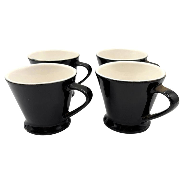 Black Ceramic California Pottery 4 Piece Pedestal Coffee Cup Set by Chefsware: Classic set of 4 pedestal coffee mug restaurant ware, often associated with mid-century diners. They feature a distinct flared shape, a footed base, and a two-tone black exterior with a white interior