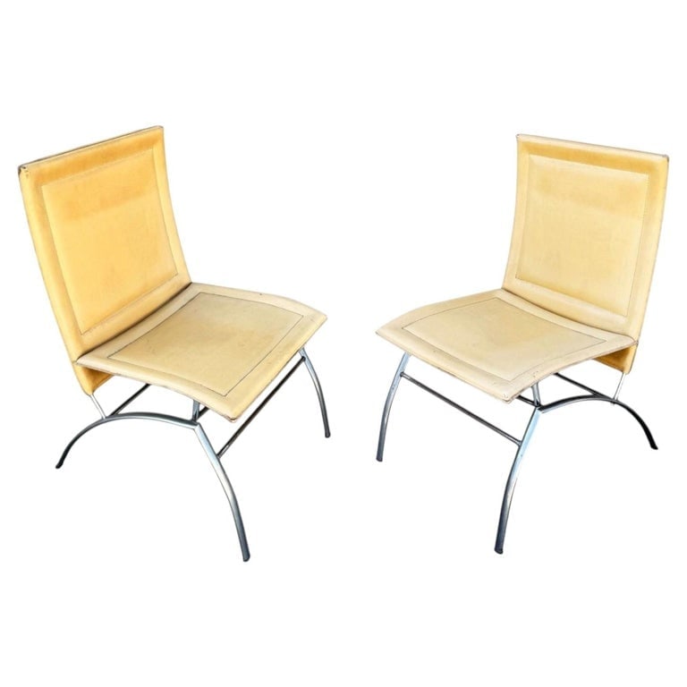 Postmodern Italian Leather œWaist? Side Chrome Tublar Lounge Chair: Offered is a sculptural pair of Postmodern Italian lounge or side chairs featuring distinctive œwaist? legs that create an elegant, tailored silhouette. The chair is upholstered in soft cream leather