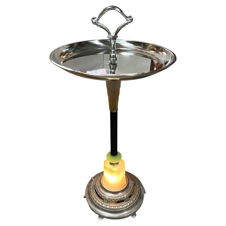 Chrome Streamline Art Deco Drink Side Glass Top Table w/ Light Up Base: Art Deco chrome round chrome top side drinks table featuring a light-up art glass base. This dual-purpose accent lamp and side table piece boasts a streamlined design that seamlessly blends elegance a