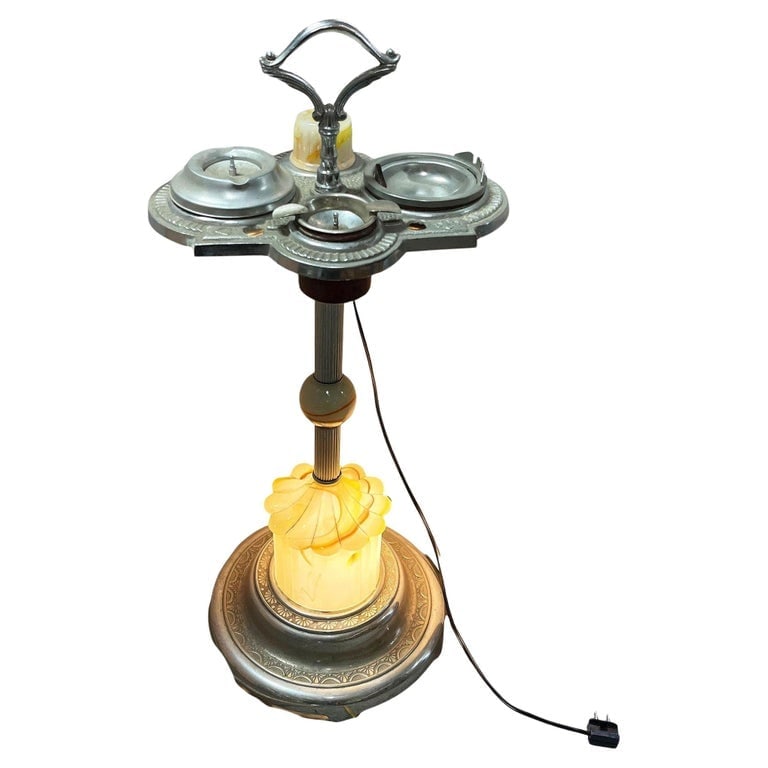 Art Deco Light Up Chrome Ashtray Stand w/ Electric Lighter and Art Glass Base: Art Deco chrome Astray Stand featuring a light-up art glass base. This dual-purpose accent lamp and ashtray piece boasts a streamlined design, blending elegance and practicality. With its integrated