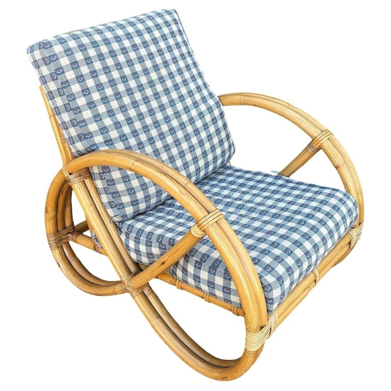 Restored Mid-century Double Strand Full Round Rattan Lounge Chair: Beautifully restored rare two-strand round full pretzel arm rattan lounge chair with fancy wicker wrappings. This design is commonly attributed to designer Paul Frankl. It features the iconic, sweepin