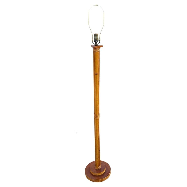 Restored Mid-century Three-Pole Rattan Floor Lamp w/ Mahogany Base: This beautifully restored Rattan pole lamp featuring 3 decorative rattan poles centered around a rattan post all fixed to a Mahogany base with reed rattan trim. The lamp features coastal styling blend