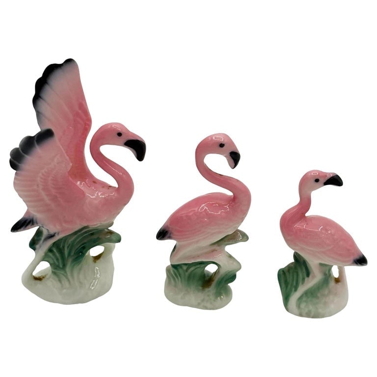 MCM Ceramic Miniature Pink Flamingo Tabletop Statue Set of 3: Mid-century pink and green ceramic flamingo statue set of 3. The set features three beautifully detailed pink flamingos in lush green leaves and grass with a pink color. Each comes with a gloss finish
