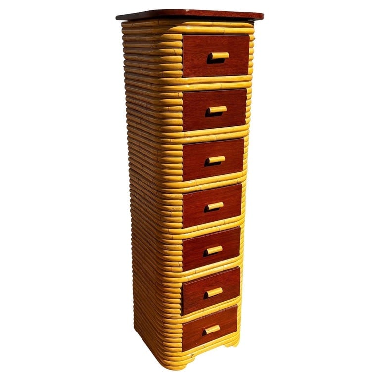 Restored Paul Frankl Style Stacked Rattan and Mahogany Petite Chest of 7 Drawers: Restored Art Deco era rattan chest of drawers with a mahogany top and seven pull-out mahogany fronted drawers. The petite chest is a perfect blend of functionality and Pacific Island/Hawaiian-inspired