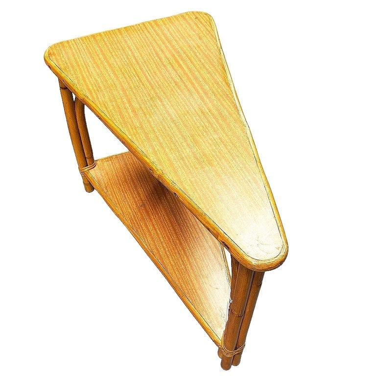 Restored MCM Rattan and Formica Skinny Arch 3-Strand Wedge Side Table w/ 2-Tiers: This beautifully restored rattan wedge table blends style and vintage charm with modern comfort. Made in circa 1940, this seven-piece living room set showcases the iconic 3-strand 3/4 pretzel arm desi