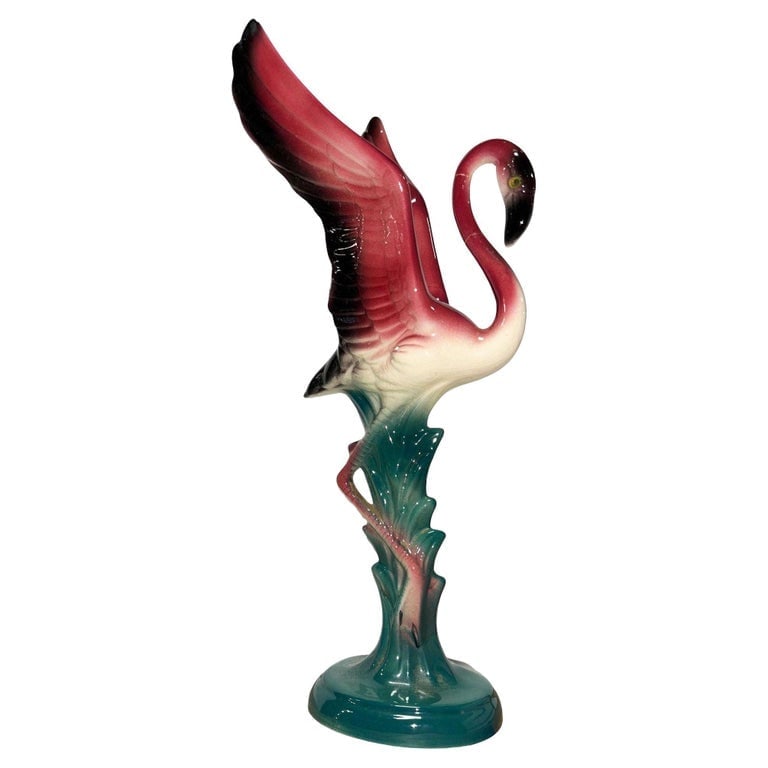 Mid-century Open Wing Pink Flamingo Ceramic Tabletop Statue: Mid-century pink and green ceramic Mother and child tabletop pottery statue. The statue features a beautifully detailed pink flamingo standing on a grassy field. It comes in a gloss finish that highli
