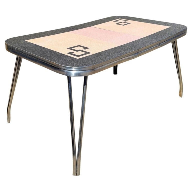 Mid-century Pink and Black Formica and Polished Chrome Kitchennette Dining Table: A striking Mid-Century Modern chrome and pink Formica dining table featuring a sleek atomic-age design. The tabletop showcases a geometric pink and black patterned laminate surface framed by a dark