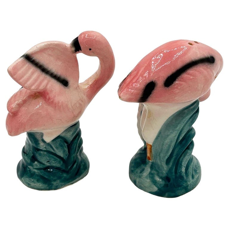 Mid-century Light Pink Flamingo Tropical Leaf Ceramic Salt and Pepper Shaker Set: Mid-century pink and green ceramic flamingo tabletop salt and pepper shaker set. The set features two beautifully detailed pink flamingos in lush green leaves and grass with a pink color. Measurements