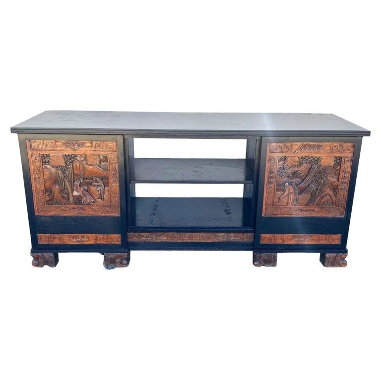 Mid-century James Mont Style Carved Media Credenza Stereo Cabinet: This beautifully restored Mid-century Credenza Media Console with hand-carved asian scenics along the front doors in the style of James Mont. The cabinet features a working AM Radio on the left side b