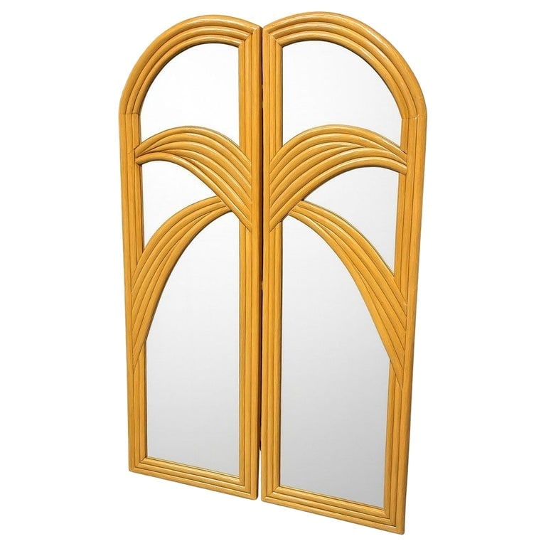 Restored Art Deco Palm Frond Design Rattan Mirror Folding Screen: This beautifully restored Art Deco rattan folding screen mirror featuring two hinged panels with arched tops and curved layered rattan detailing blending style and vintage charm with modern comfort.. 