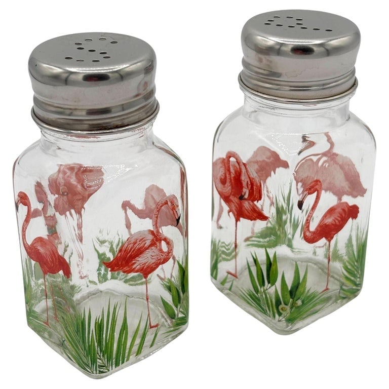 Hand Painted Pink Flamingo Glass Salt and Pepper Shakers by Michel Design Works: Hand-painted clear glass Salt and Pepper Set with Pink Flamingos scenic along the front by Michel Design Works . Each shaker features a pair of beautiful tropical pink Flamingos standing in a grassy