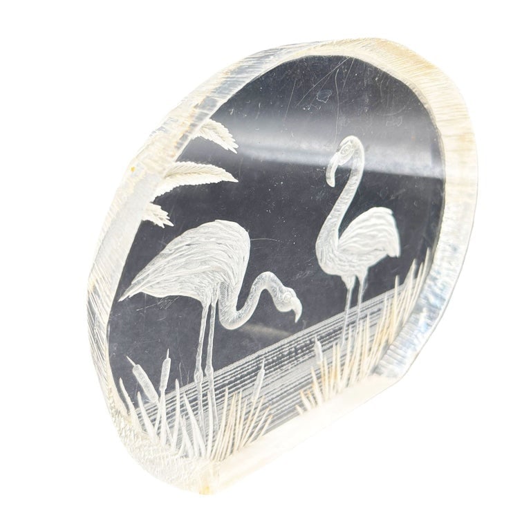 Modern Flamingos In Water Round Reverse Carved Lucite Paperweight Sculpture: Modern 1980s flamingos in water, reverse carved lucite paperweight Sculpture. This lucite paperweight sculpture features a rounded shape with a hand-carved scene of flamingos resting on the beach duri