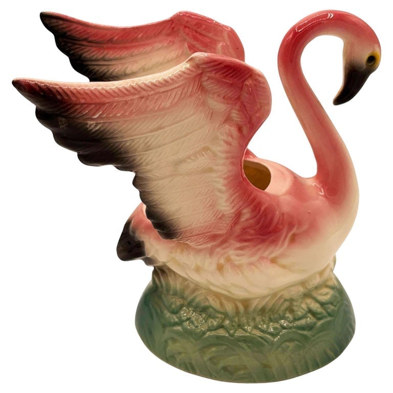 Mid-century California Pottery Ceramic Pink Flamingo Table Planter w/ Light Base: Mid-century pink and green California Pottery ceramic open-wing flamingo tabletop planter. The planter features a beautifully detailed pink flamingo landing on a light green grassy field. It comes in 