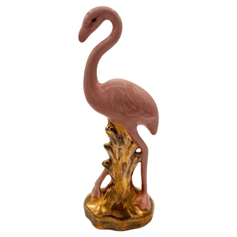Mid-century Ceramic Fancy Bird Pink and Gold Flamingo Tabletop Statue: Mid-century pink and gold flamingo ceramic figurine. The statue features a pink flamingo with long legs, a slim, tall form standing on a grassy field, looking in curiosity. It comes in a gloss finish