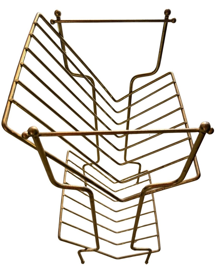 Mid-Century Modern Brass-Toned Metal Magazine Rack: This magazine rack embodies the sleek and functional design characteristic of Mid-Century Modern aesthetics. Crafted from brass-toned metal, it features a sturdy wire frame construction with multiple