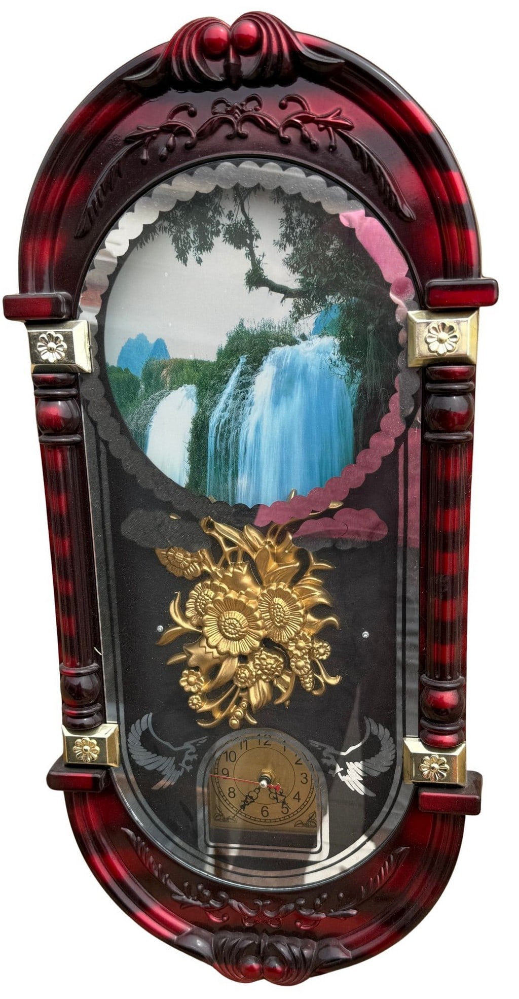 Vintage Musical Waterfall Clock: This vintage wall clock features a decorative red and gold plastic frame, encompassing an animated waterfall scene with a gold-tone floral appliquÃ©. The clock face is integrated into the
