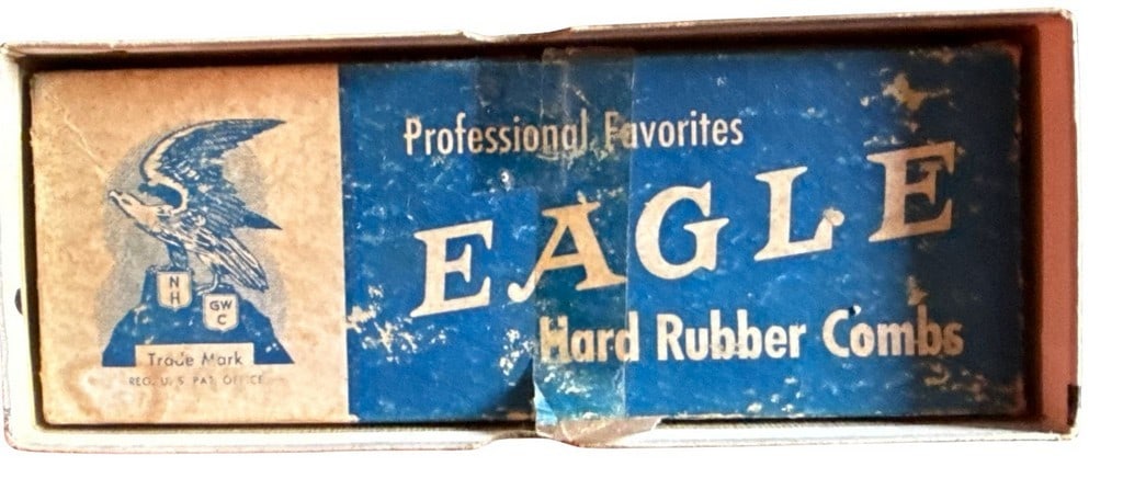 Vintage Eagle Hard Rubber Combs in Original Box: A set of vintage "Professional Favorites" Eagle brand hard rubber combs in their original blue and white cardboard box. The box features an eagle graphic and text indicating "Trade Mark". The combs th