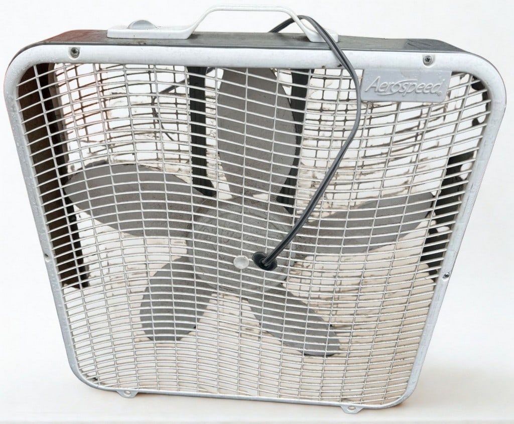 AeroSpeed Vintage Box Fan: This vintage AeroSpeed box fan, likely from the mid to late 20th century, features a gray metal casing with white plastic grilles and fan blades. The design is utilitarian, typical of household applia