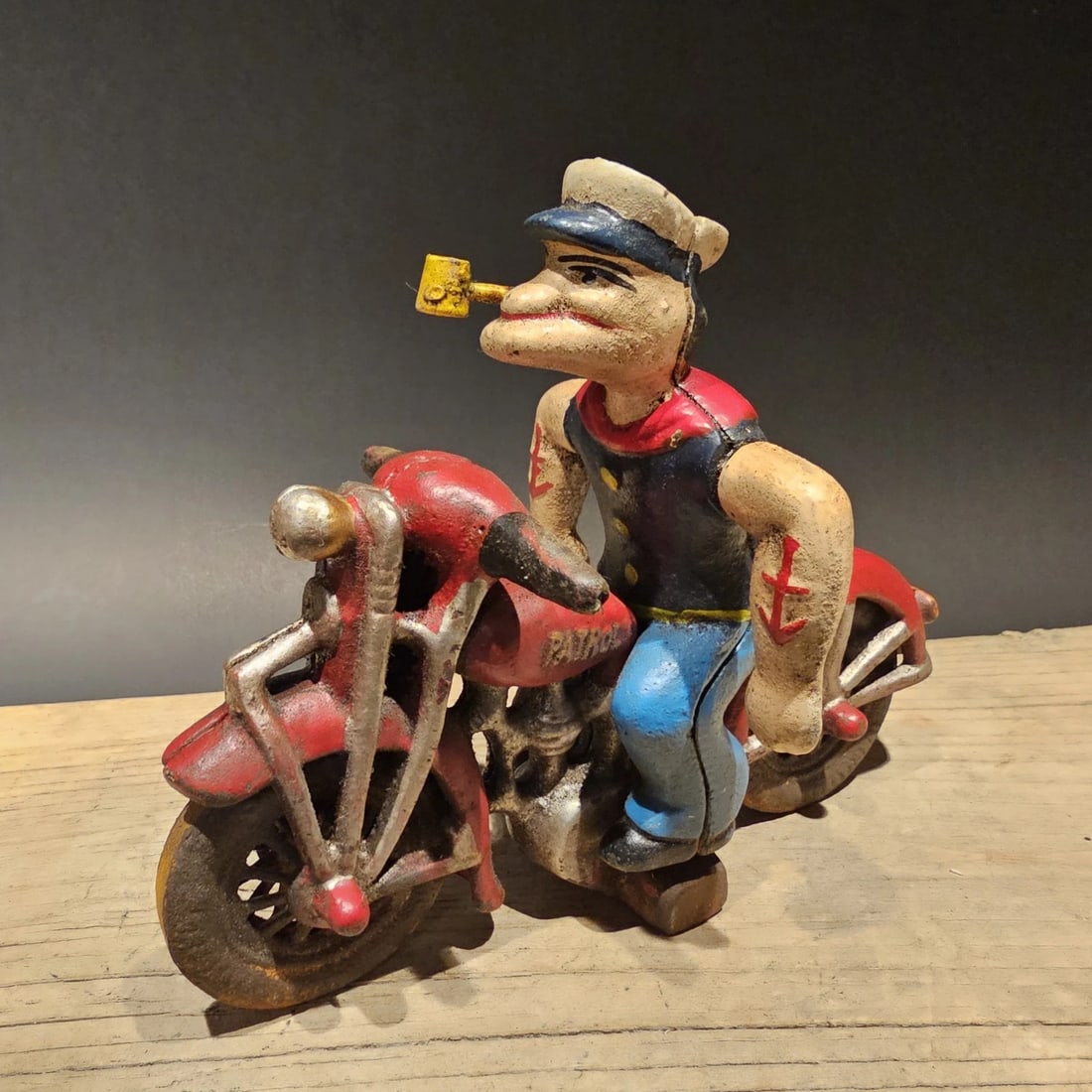 Cast Iron Saylor on Patrol Motorcycle: 8" x 6", Heavy Cast Iron - 3+ Pounds Such a neat reproduction cast iron motorcycle! As you can see this heavy cast iron pull toy motorcycle was wonderfully hand painted and distressed to look like an