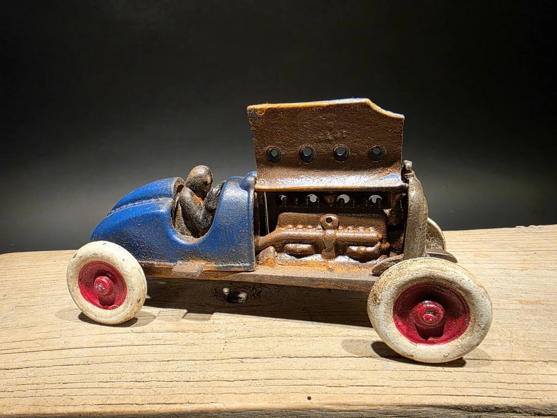 Blue Cast Iron Toy Race Car w Lifting Hood: 9" Long x 3 1/2" Wide 3 3/4" Tall 2 lbs 13 oz Such a neat reproduction cast iron car! As you can see this heavy cast iron car was wonderfully hand painted and distressed to look original. The car is