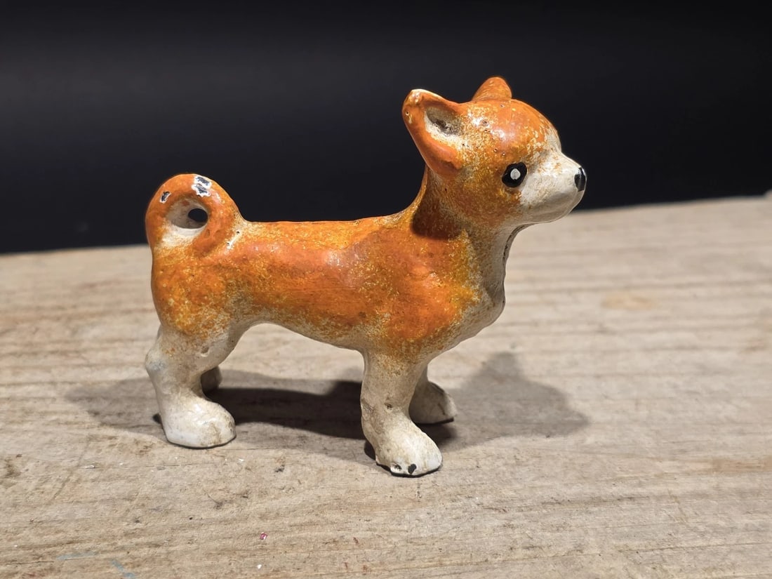 Miniature Cast Iron Chihuahua Dog Figurine Dog: Small cast iron dog figurine depicting a Chihuahua with upright ears and curled tail. Dog figures of this type were commonly produced as decorative novelties and toy animals during the late 19th and e
