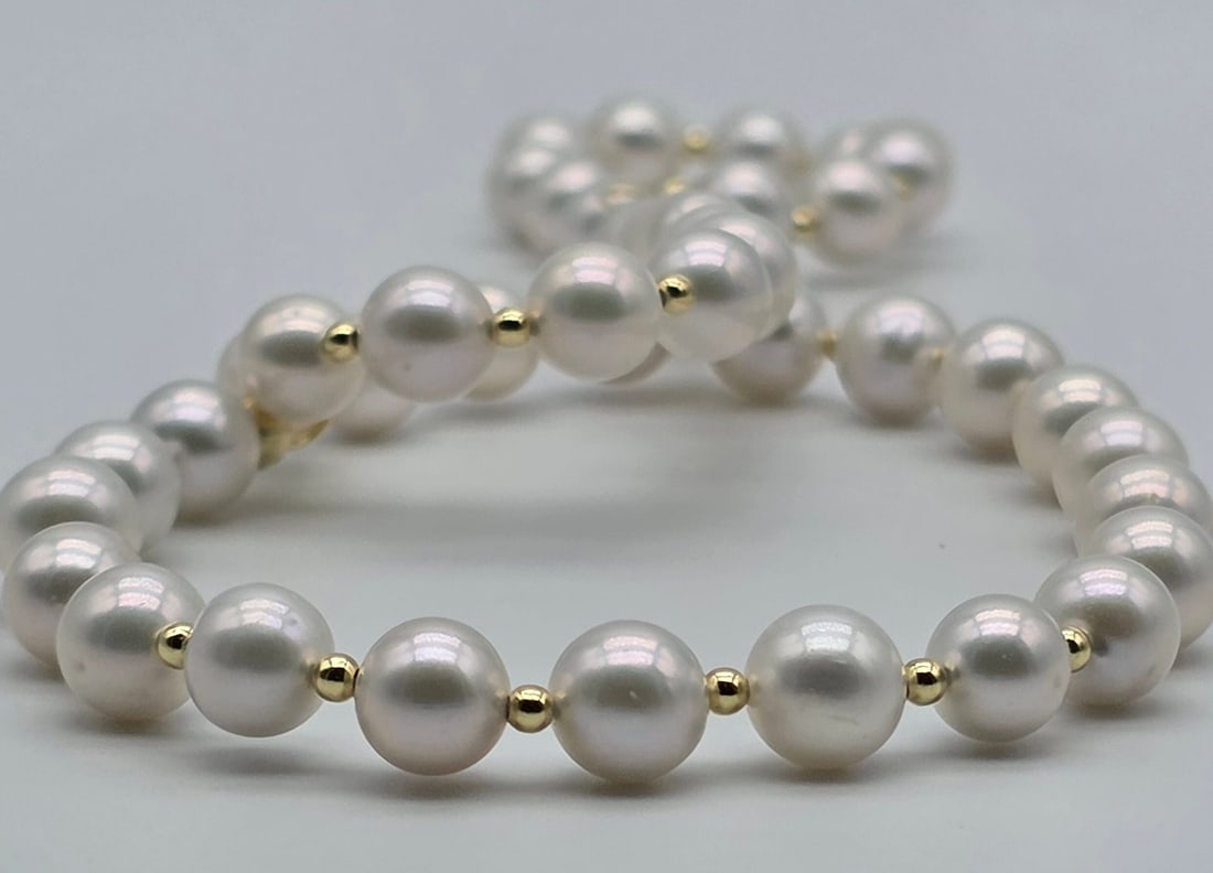 Akoya Pearl Necklace With 18kt Yellow Gold Spheres: Title:Akoya pearl necklace with 18kt yellow gold spheres Description:Akoya pearl necklace with 18kt yellow gold spheres 18kt (750) yellow gold hook clasp The pearls have a diameter ranging from 6.5 to
