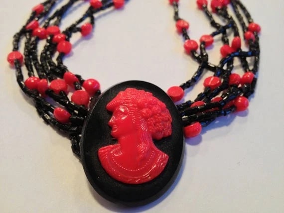 Multi Strand Red And Black French Jet Glass Bead Necklace W/ Cameo Pendant: Title:Multi Strand Red and Black French Jet Glass Bead Necklace w/ Cameo Pendant Description:Striking mutli strand necklace of red and black french jet glass beads with a cameo pendant. Circa 1920's. 