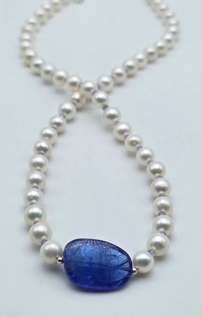 Akoya Pearl Necklace With A Central Tanzanite, Gold Spheres, Tanzanite Rondelles Between Each Pearl,: Title:Akoya pearl necklace with a central tanzanite, gold spheres, tanzanite rondelles between each pearl, and an 18kt white gold clasp Description:Akoya pearl necklace with a central tanzanite, gold