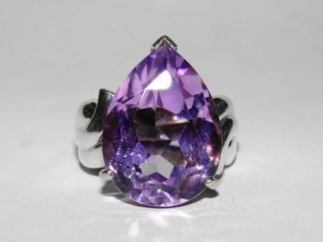 Retro Purple Amethyst Pear Cocktail Ring: Title:Retro Purple Amethyst Pear Cocktail Ring Description:Massive pear shaped cocktail ring with a gorgeous natural purple amethyst. Circa, 1970's. Pear measures 20 mm's by 15 mm's. Ring has gorgeous