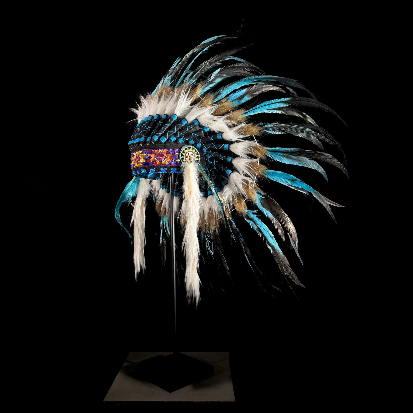 Beautiful remake of an Indian Headdress on a custom stand: Title: Beautiful remake of an Indian Headdress on a custom stand Maker:Unknown Origin: Indonesia Date/Period:2026 Materials:Feathers, Beads, Steel, natural fibres Dimensions:Height including stand: