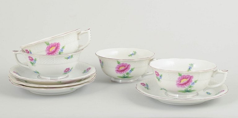 Herend, Hungary. Set of four porcelain teacups with saucers with flowers in pink and blue tones. (1 of 4)
