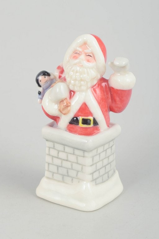 Royal Copenhagen, Denmark. Rare Santa Claus porcelain figurine standing in a chimney holding a small (1 of 5)