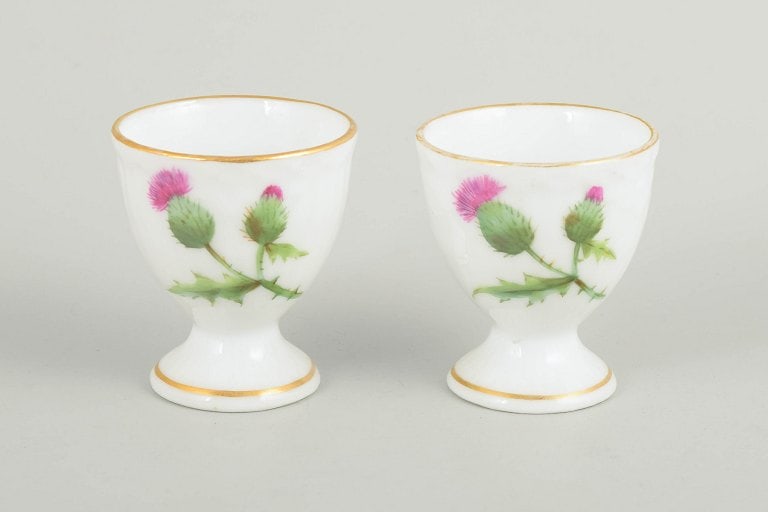 Royal Copenhagen, Denmark. Thistle, two porcelain egg cups in green and pink tones decoration. (1 of 4)