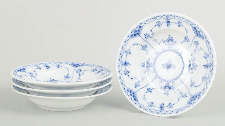 Royal Copenhagen, Denmark. Blue Fluted Half Lace, set of four porcelain small deep plates with: Royal Copenhagen Blue Fluted Half Lace, set of four small deep plates. Set of four small breakfast deep plates in hand-painted porcelain from the Blue Fluted Half Lace service with classic underglaze 