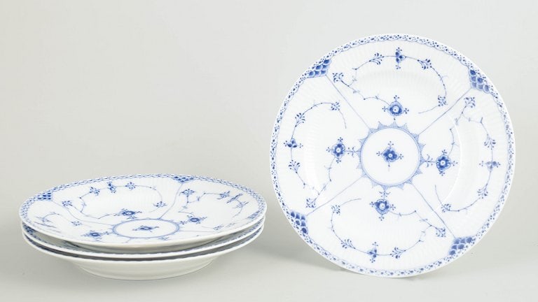 Royal Copenhagen, Denmark. Blue Fluted Half Lace, set of four porcelain dinner plates with: Royal Copenhagen Blue Fluted Half Lace, set of four dinner plates. Set of four dinner plates in hand-painted porcelain from the Blue Fluted Half Lace pattern with classic underglaze decoration in coba