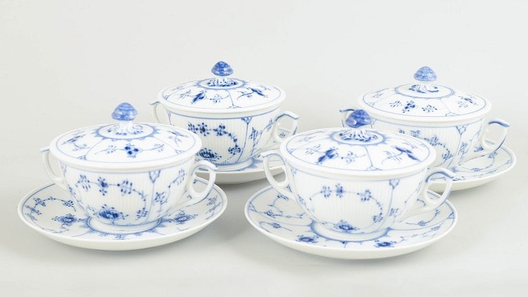 Royal Copenhagen, Denmark. Blue Fluted Plain, set of four porcelain bouillon cups with matching: Royal Copenhagen Blue Fluted Plain, set of four bouillon cups with matching saucers. Set of four bouillon cups with matching saucers in hand-painted porcelain from Blue Fluted Plain with classic under