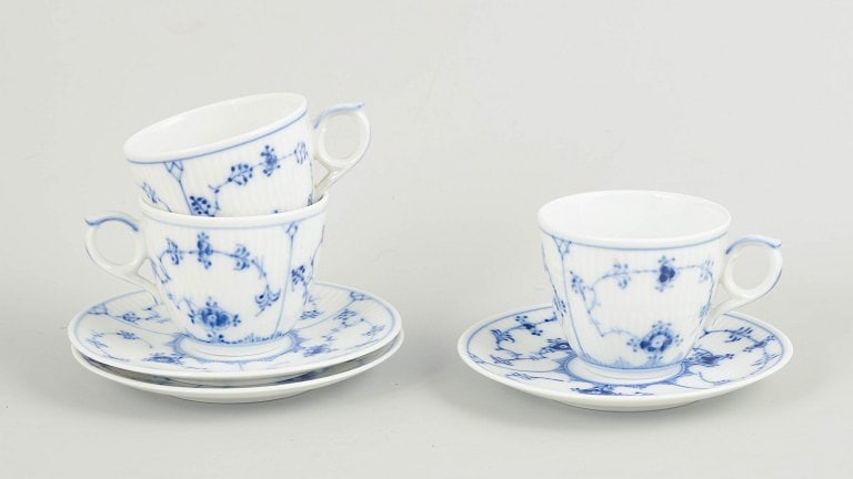 Royal Copenhagen, Denmark. Blue Fluted Plain Set of three porcelain cups with matching saucers with: Royal Copenhagen Blue Fluted Plain, set of three demitasse cups with matching saucers. Set of three demitasse cups with matching saucers in hand-painted porcelain from Blue Fluted Plain with classic u