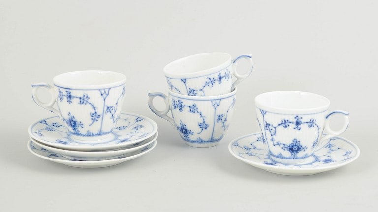 Royal Copenhagen, Denmark. Blue Fluted Plain Set of four porcelain cups with matching saucers with: Royal Copenhagen Blue Fluted Plain, set of four demitasse cups with matching saucers. Set of four demitasse cups with matching saucers in hand-painted porcelain from Blue Fluted Plain with classic und