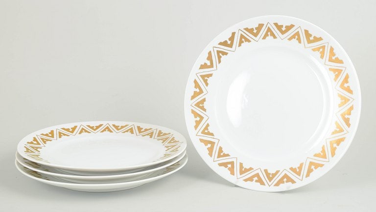 Royal Copenhagen, Denmark. Set of four large porcelain dinner plates with geometric Art Deco style: Royal Copenhagen set of four large dinner plates. Set of four large porcelain dinner plates with geometric Art Deco style decoration along the rim. Cancelled with two incised lines on the base.